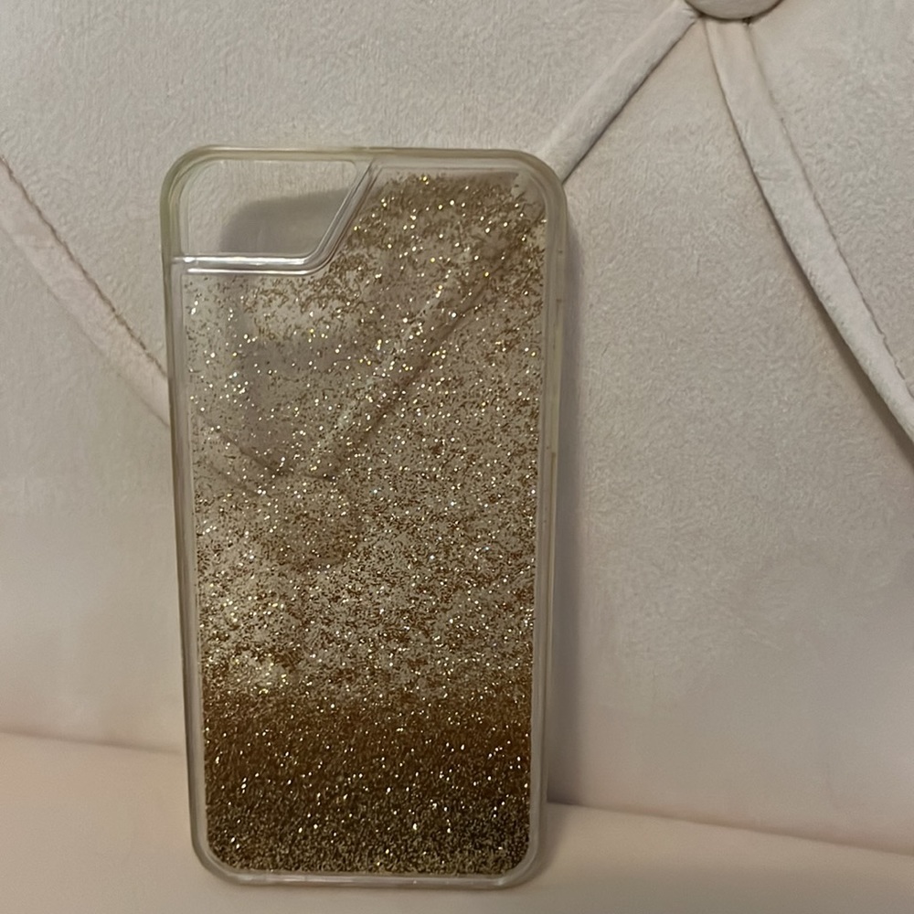 Clear case with gold sparkles that move within the case